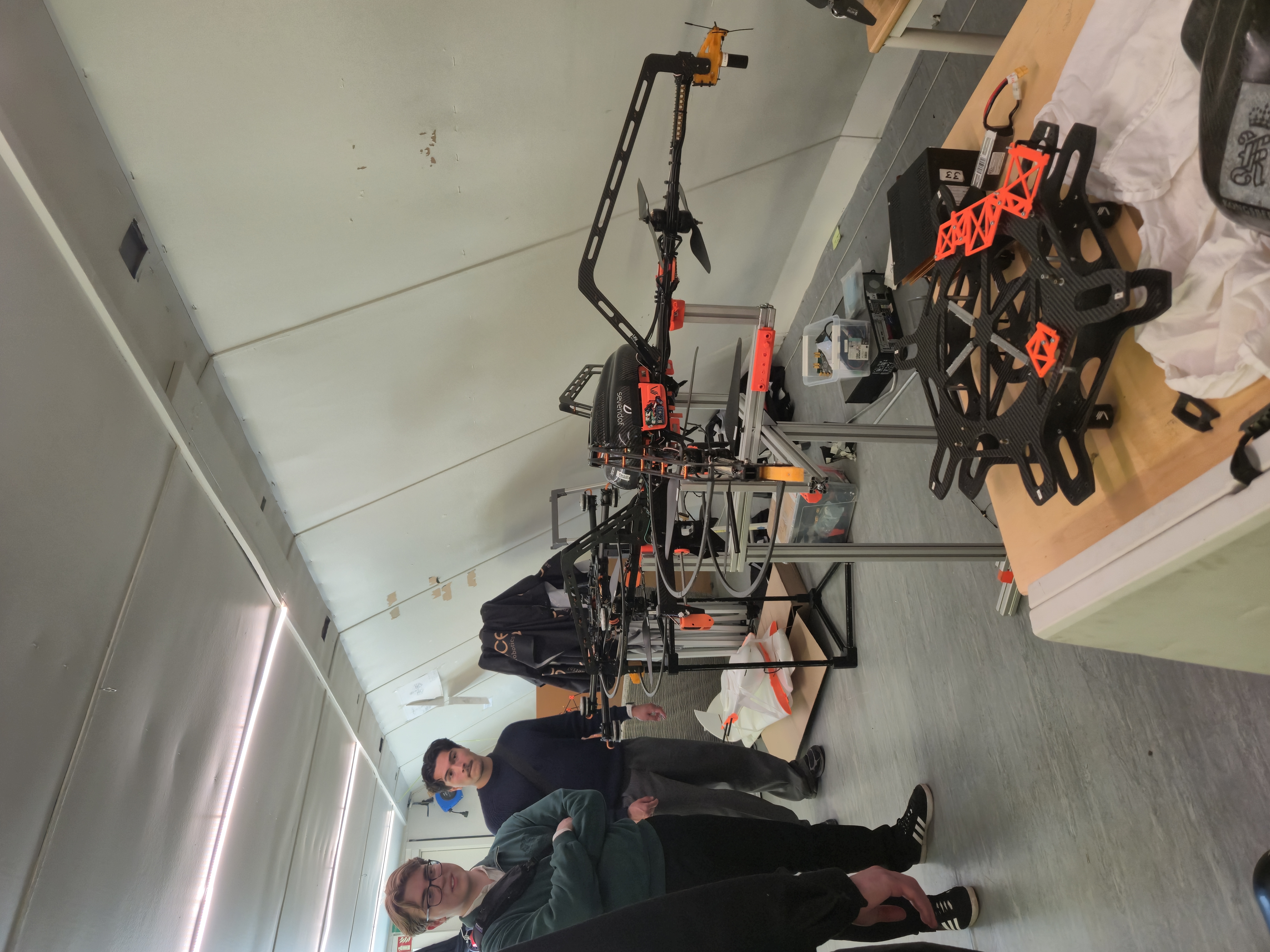 Two members posing in front of Ascend NTNU's large autonomous drone.